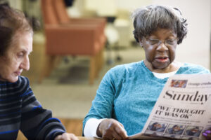 Social Day participants read newspaper