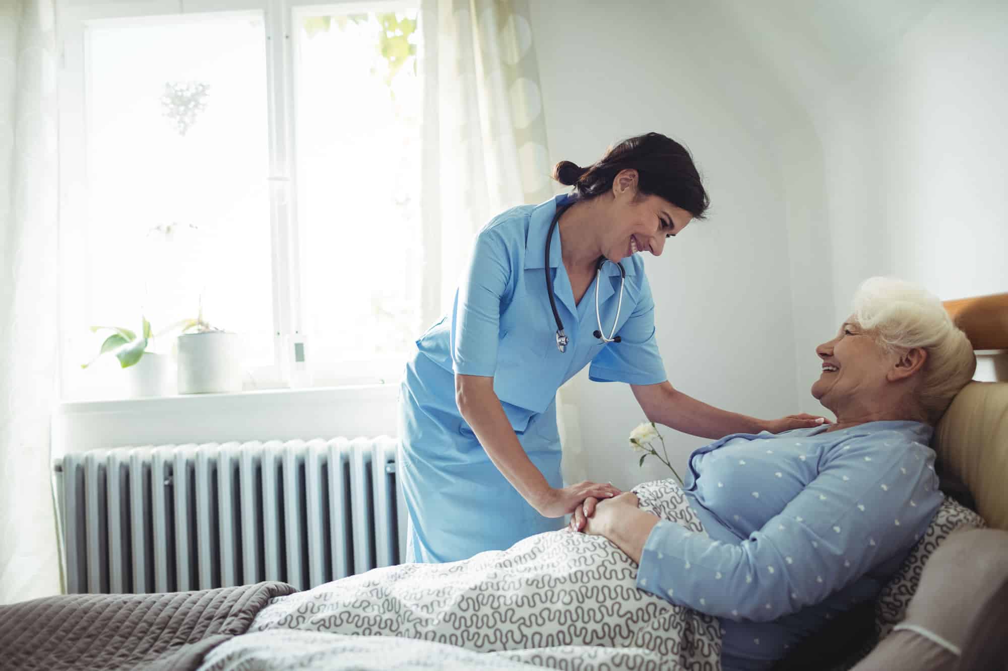 nurse providing care to bedridden patient