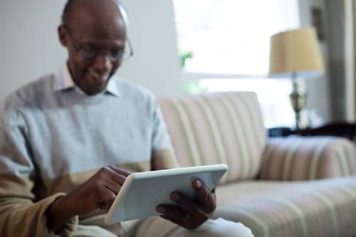 Senior Man on Tablet Smiling