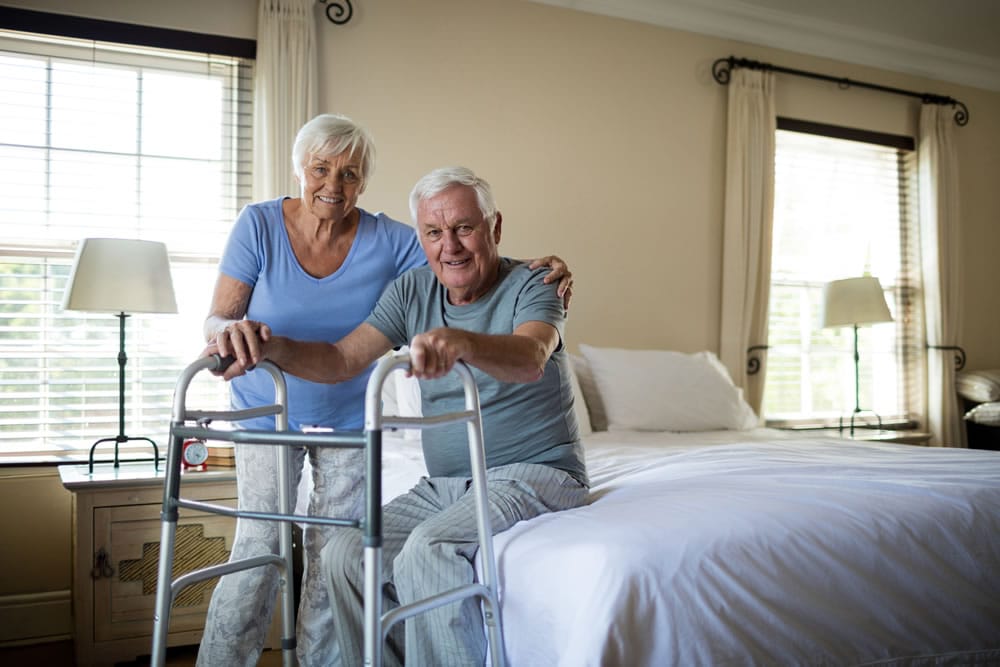 Senior Couple in Bed with Walker